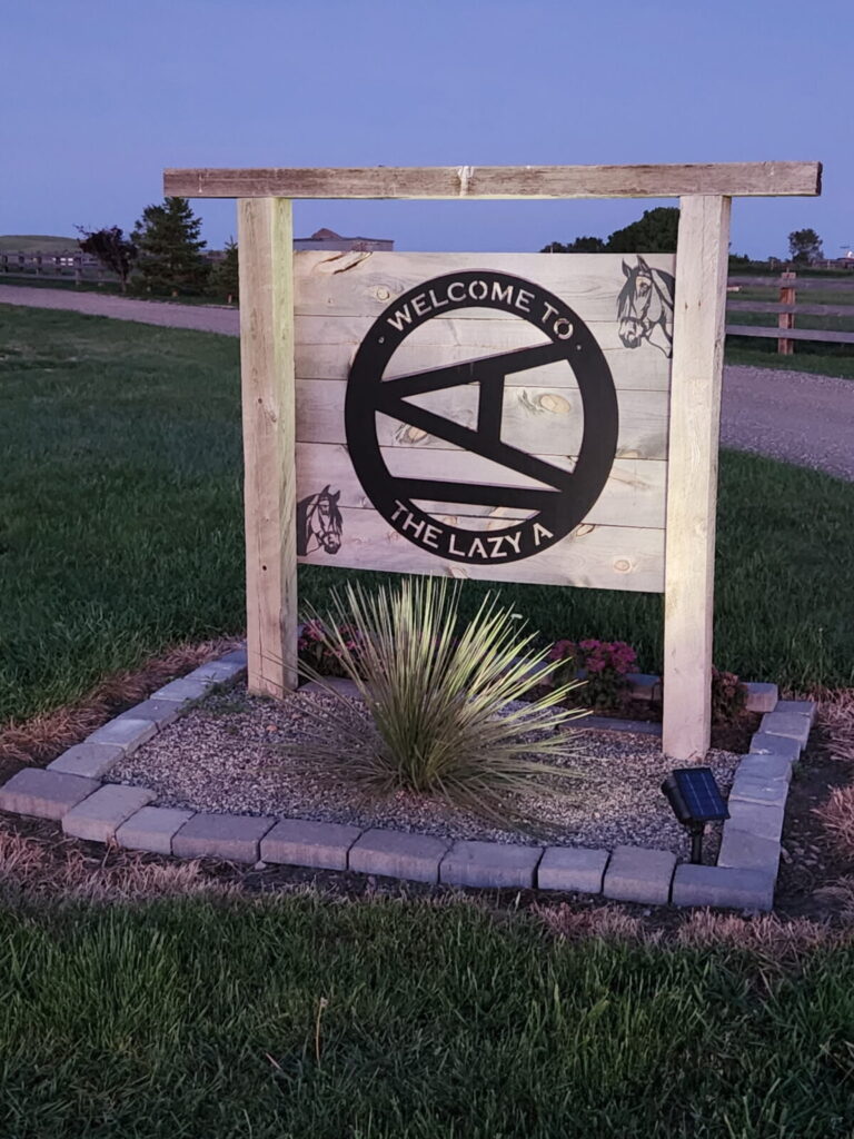 Welcome to the Lazy A Ranch entrance sign with the Lazy A horse brand