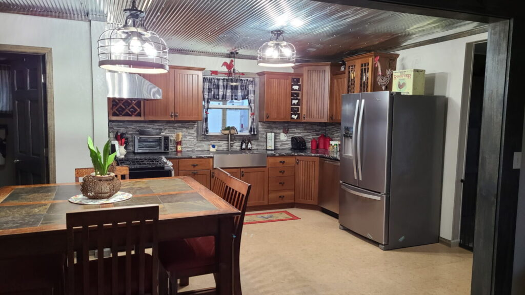 Full farmhouse kitchen with stainless appliances at the Lazy A Ranch guest house