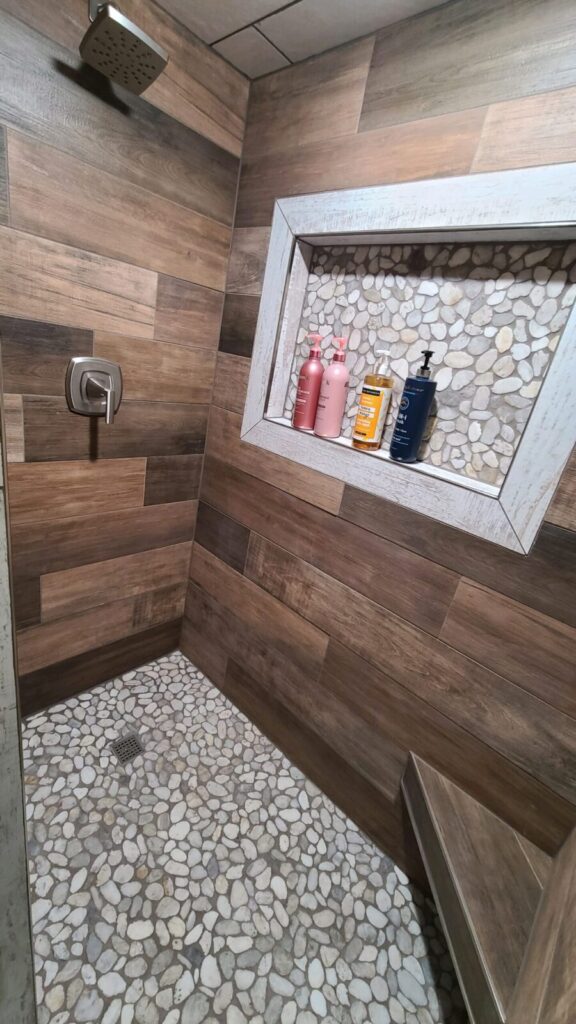 Wood-look tile and pebble walk-in shower at the Lazy A Ranch